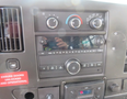 Dashboard of a 2020 Chevrolet Express showing climate control knobs and a radio control panel with various buttons