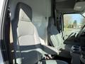 Two grey upholstered seats are visible in the front of a 2012 Ford Econoline E-450 interior with armrests and seat belts