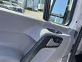 A close-up view of the interior door panel of a 2010 Mercedes-Benz Sprinter showing the handle and control buttons