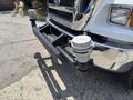 A 2015 Ford F-750 truck featuring a black front bumper with two attached silver air tanks and a hitch receiver under the grille