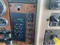 Dashboard controls of a 2008 Peterbilt 340 featuring buttons for start and stop functions along with temperature gauge and various switches for vehicle operations
