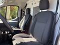 Interior of a 2016 Ford Transit showing two black fabric seats with a steering wheel and dashboard visible in the foreground