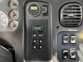 The dashboard of a 2012 Freightliner M2 106 displaying various gauges and controls including an electronic transmission shifter and temperature gauge