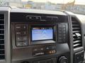 The dashboard of a 2020 Ford F-550 featuring a digital display with radio controls and buttons for media and air settings