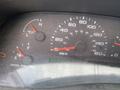 Dashboard of a 2002 Ford F-550 showing speedometer fuel gauge and other indicators in a dusty condition