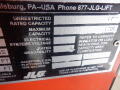 A label on a 2008 JLG Boom Lift displaying specifications including rated capacity, maximum capacity, electrical systems voltage, and rated gradability