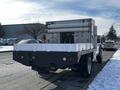 2011 Ford F-450 SD with a flatbed and a silver utility box attached to the rear featuring multiple pipes and storage compartments