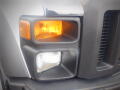 Close-up of the front headlights and turn signal of a 2008 Ford F-550