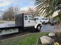 A 2006 Ford F-650 flatbed truck is parked at an angle showcasing its large size and dual rear wheels