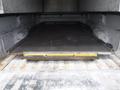 A 2015 Chevrolet Silverado 1500 with a lowered tailgate revealing a flat loading bed inside the cargo area