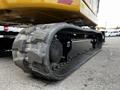 A close-up view of the tracked undercarriage of a 2024 Caterpillar 306 showing the rubber tracks and durable components designed for excavation and earthmoving tasks