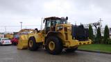 A 2019 Caterpillar 972M XE wheel loader with a large front bucket and large tires, designed for heavy lifting and earthmoving tasks