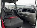 Interior of a 2021 Mitsubishi FE showing two cloth seats with a red seatbelt and a dashboard featuring multiple controls and displays