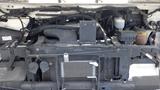 A 2011 Ford Econoline engine compartment showcasing various engine components and wiring