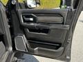 Interior door panel of a 2022 RAM 3500 featuring a sleek black design with a handle control panel and speaker integrated into the layout