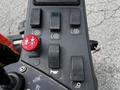 Control panel of a 2015 Jacobsen Eclipse with several buttons and switches including navigation lights and horn controls