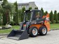 A 2017 Gehl R105 skid steer loader with a black and orange design features a front bucket and four wheels, ready for construction or landscaping tasks