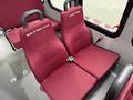 Two maroon upholstered seats in a van with seatbelts and labels for Nolan & Gwen Crowe and George Crawling