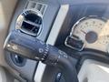 A close-up of the control stalk of a 2013 Ford Expedition featuring settings for turn signals and windshield wipers