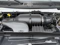 Close-up of the engine compartment of a 2019 Ford Econoline showcasing the air intake and surrounding components