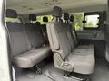 Interior view of a 2017 Ford Transit T150 XLT showing rows of fabric-covered seats with seatbelts and headrests in a spacious configuration