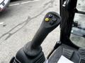 Close-up of the control joystick of a 2024 Caterpillar 306 heavy machinery with buttons for operation