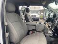 Interior view of a 2017 Ford F-550 showing front seats with gray fabric upholstery and a central console between them