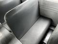 A gray vinyl seat from a 2015 Spartan School Bus with a smooth texture and a simple design