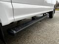 A side view of a 2020 Ford F-250 SD showcasing a rugged black running board beneath the passenger side door