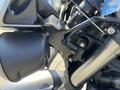 Close-up of a 2018 Triumph Street Triple RS motorcycle engine with black and silver components showcasing detailed mechanics and design elements