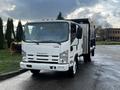 A white 2015 Isuzu NPR HD truck with a flatbed and metallic side panels parked facing the camera