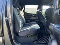 Interior view of a 2021 Toyota Tacoma showcasing the rear seating area with fabric upholstery and storage compartments