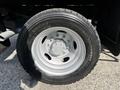 Close-up of a gray tire mounted on a silver rim for a 2016 Ford F-550 with visible tread pattern and valve stem