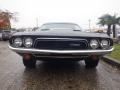 A 1974 Dodge Challenger with a black exterior and chrome grille designed to showcase its classic muscle car features