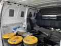 Interior of a 2018 Mercedes-Benz Metris showing a driver's seat and several yellow buckets on the floor among other materials