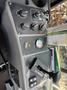 Dashboard of a 2015 Global Street Sweeper featuring various controls gauges and a lever for operation