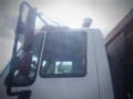 A 2016 International WorkStar 7500 truck with a white cab and large side mirrors is shown in close-up detail