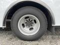 Close-up of the front wheel and tire of a 2017 Chevrolet Express showing a silver rim and dark rubber tire with visible tread patterns