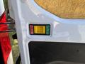 A control panel featuring a yellow button labeled "LOCK," a green button labeled "UNLOCK," and a red indicator light, mounted on the interior of a vehicle door