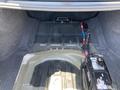 Trunk of a 2019 Dodge Charger showing a battery and exposed flooring with no cargo present