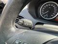 Close-up of a 2004 BMW 6-Series steering wheel and dashboard with a control switch for check and trip computer functions