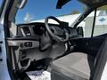 Interior of a 2022 Ford Transit showcasing the driver's seat steering wheel dashboard and control panel with a modern design and a focus on functionality