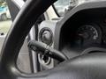 A 2017 Ford Econoline steering wheel with a control stalk for wipers and headlights in focus