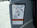 A label on a machine detailing joystick lever usage with illustrations and a warning about potential personal injury