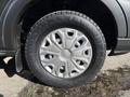 Close-up of a silver alloy wheel with a textured tire belonging to a 2017 Ford Transit