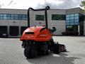 A 2015 Jacobsen Eclipse 322 3WD turf maintenance machine with an orange body and large rear tires positioned for operation