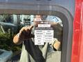 A close-up of a certification sticker on the window of a 1994 Volvo FE 42 displaying approval details and months of the year