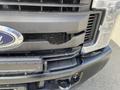A black 2017 Ford F-250 SD with visible damage to the front grille and bumper components