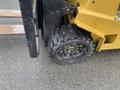 A close-up of the front wheel of a 2010 Hyster S80XLBCS forklift featuring a rugged tire with deep treads and a black rim