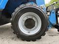 A close-up of a heavy equipment tire from a 2020 Genie GTH-5519 featuring a black rubber tread and a silver wheel rim